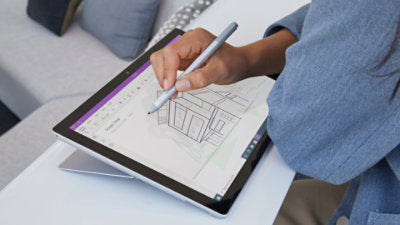 Person sketching architecture with a Microsoft Surface Pen