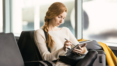 Person using a Microsoft Surface Pen while seated with a Surface device