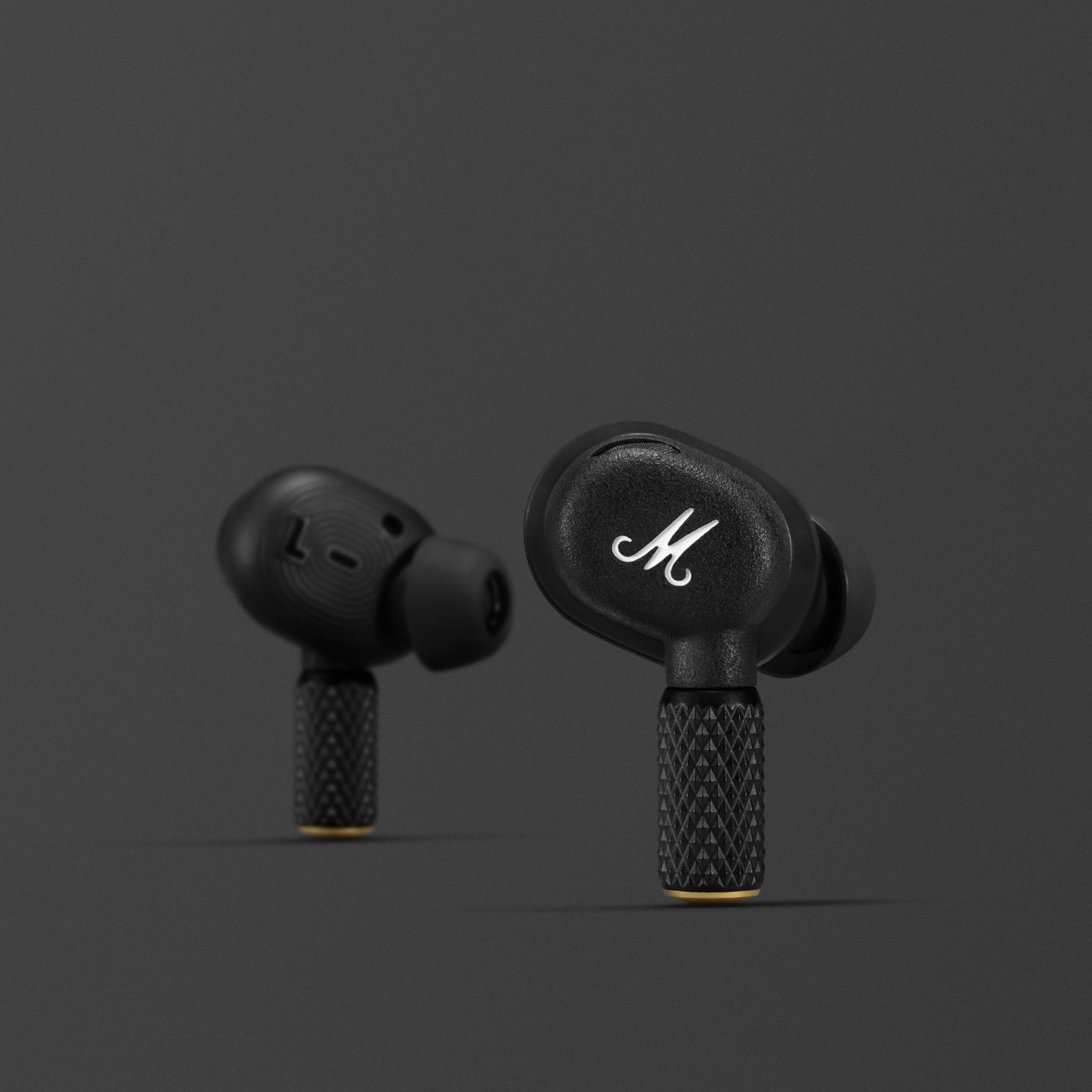 Close-up of Marshall Motif II A.N.C. earbud with M logo