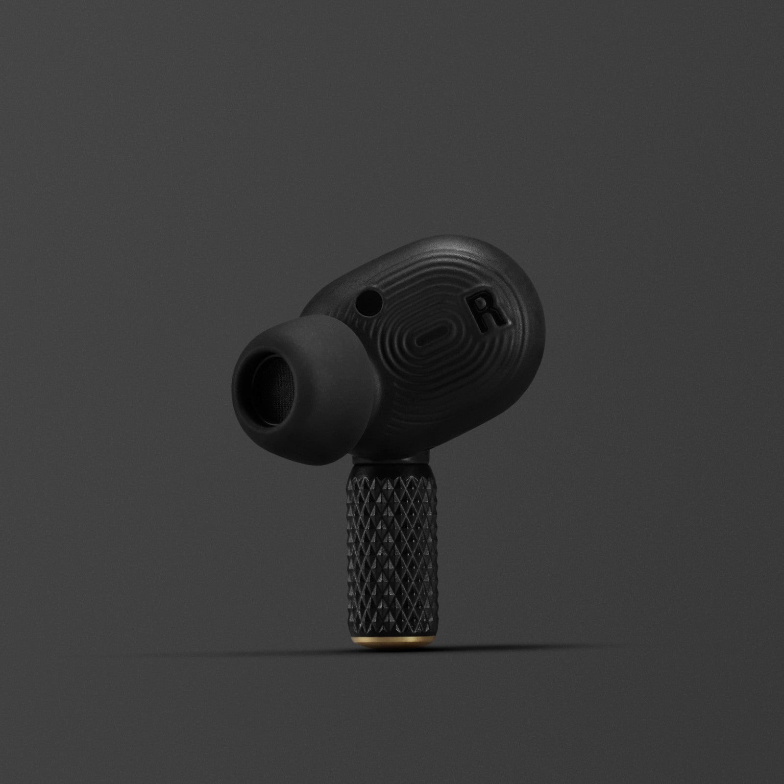 Marshall Motif II A.N.C. earbud close-up showing touch control area