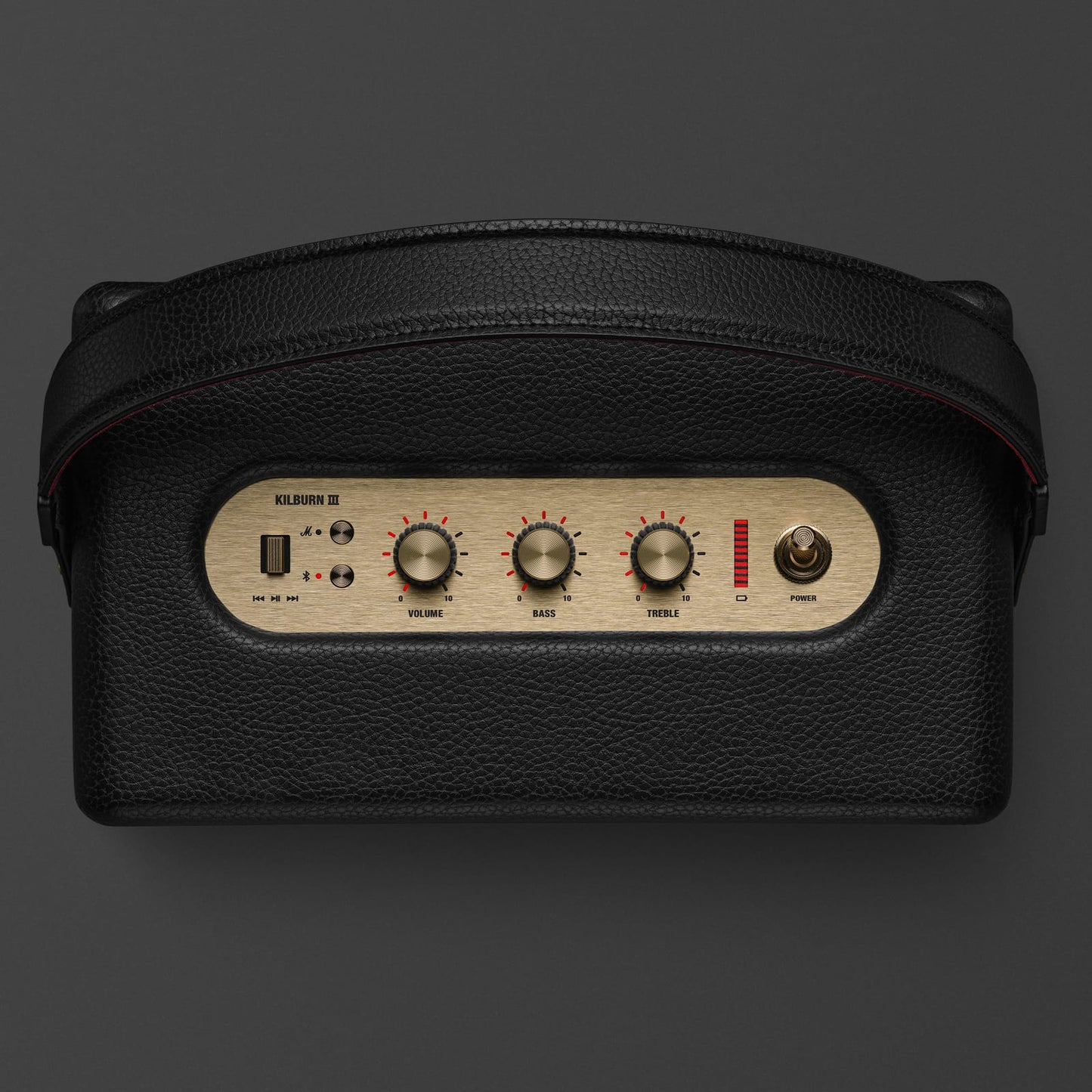 Marshall Kilburn III Black and Brass speaker being carried by handle