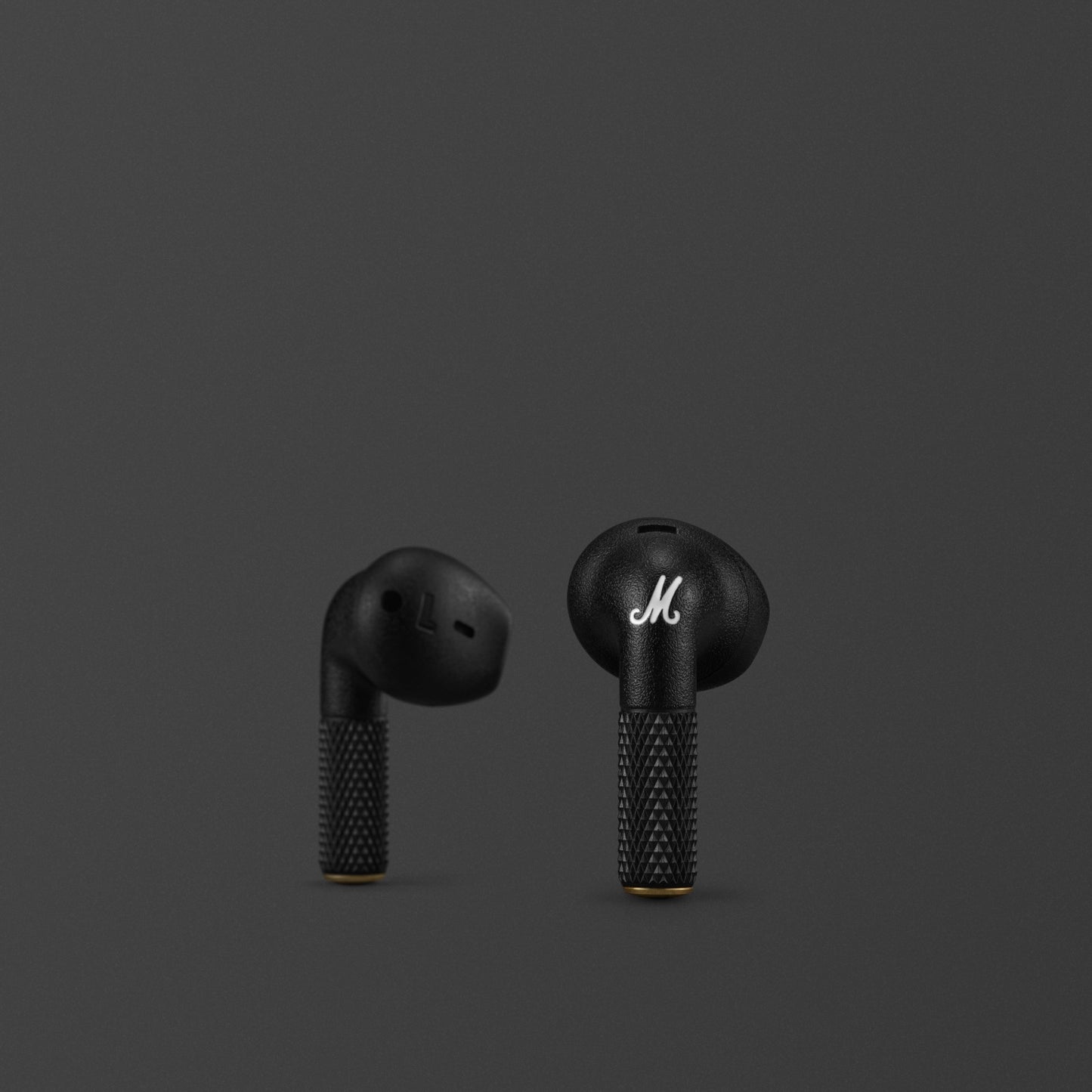 Close-up detail of Marshall Minor IV Black earbud with gold accent