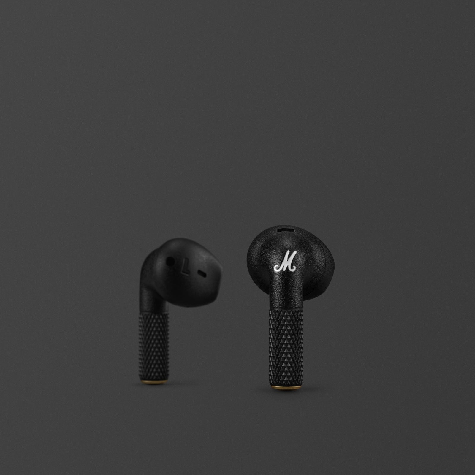 Close-up detail of Marshall Minor IV Black earbud with gold accent