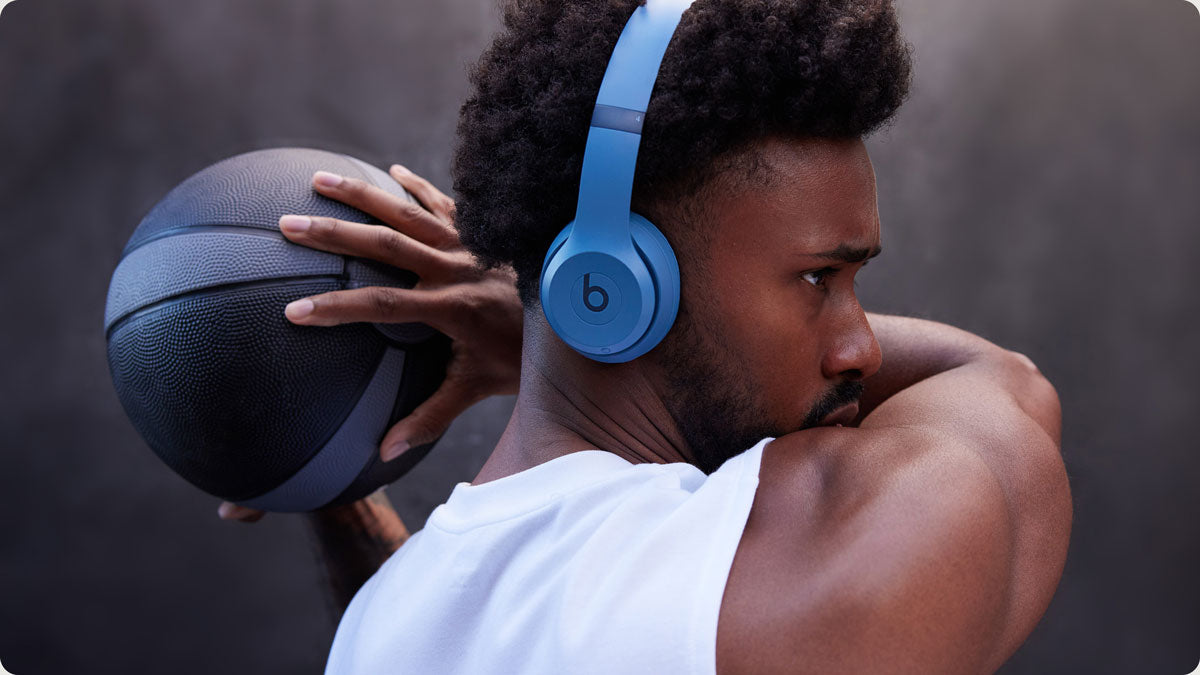 Man wearing Beats Solo 4 wireless on-ear headphones