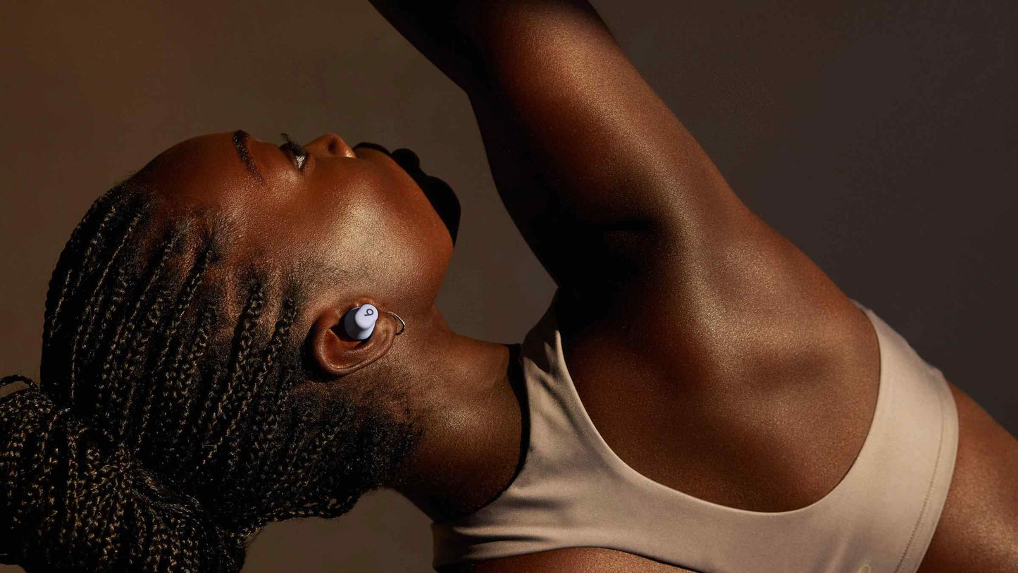 Woman wearing Beats Solo Buds true wireless earbuds