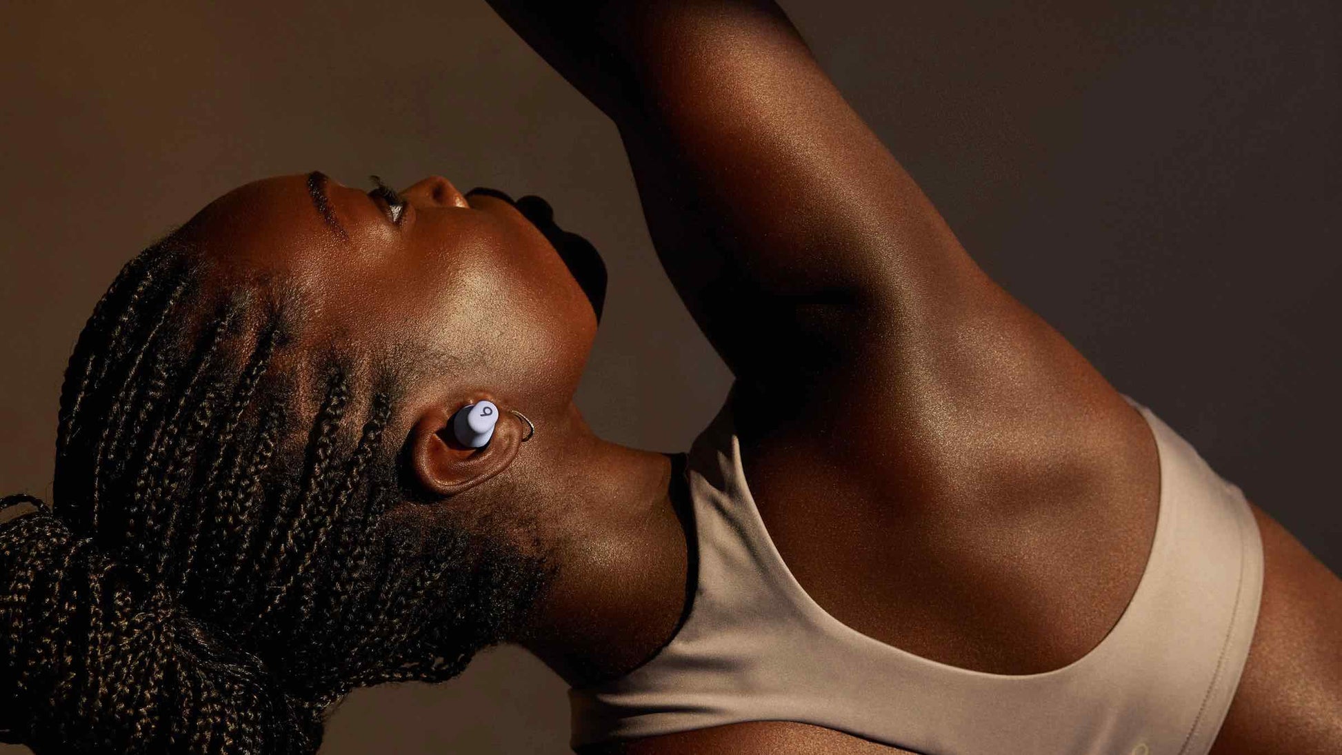 Woman wearing Beats Solo Buds true wireless earbuds
