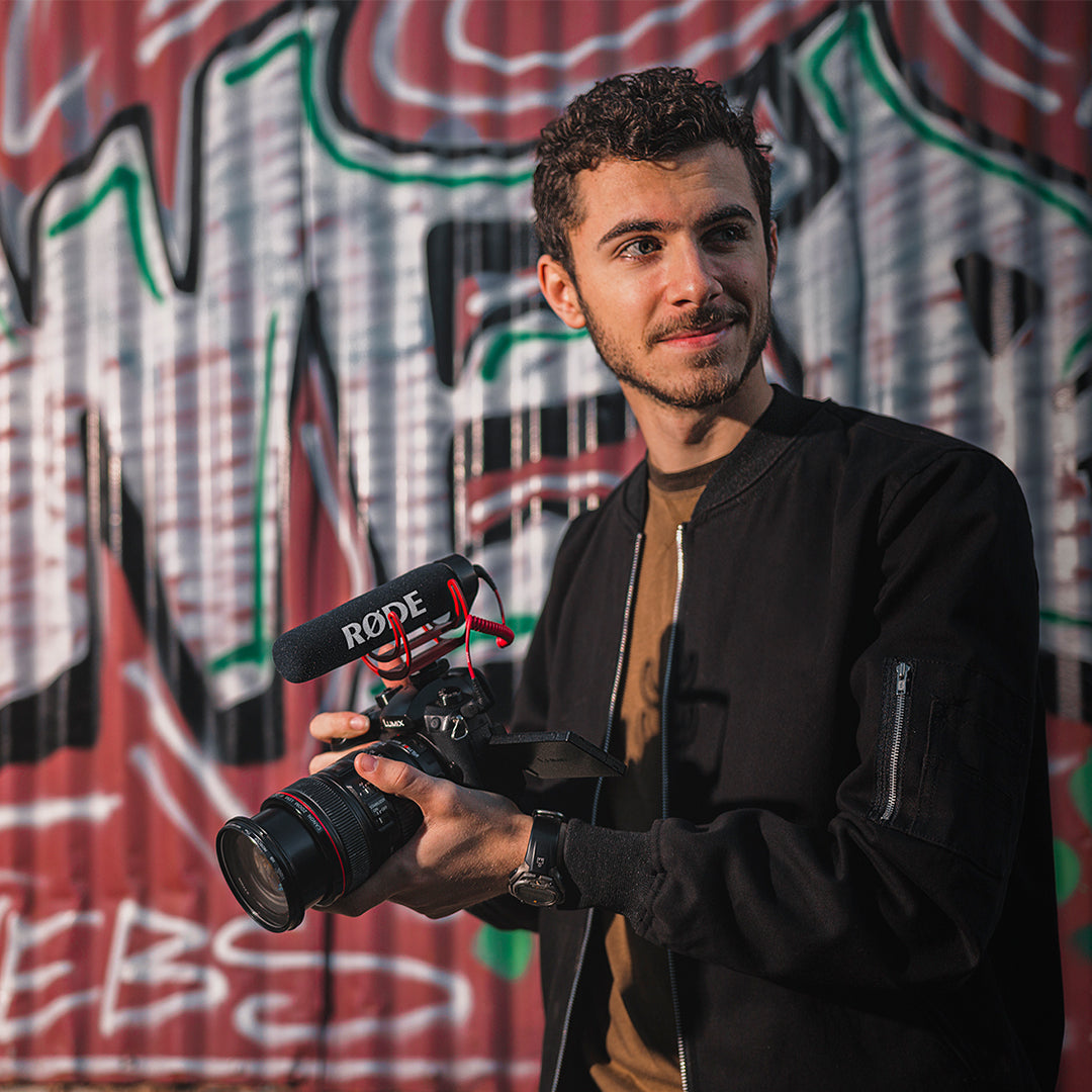 Content creator filming with camera and Rode VideoMic GO attached