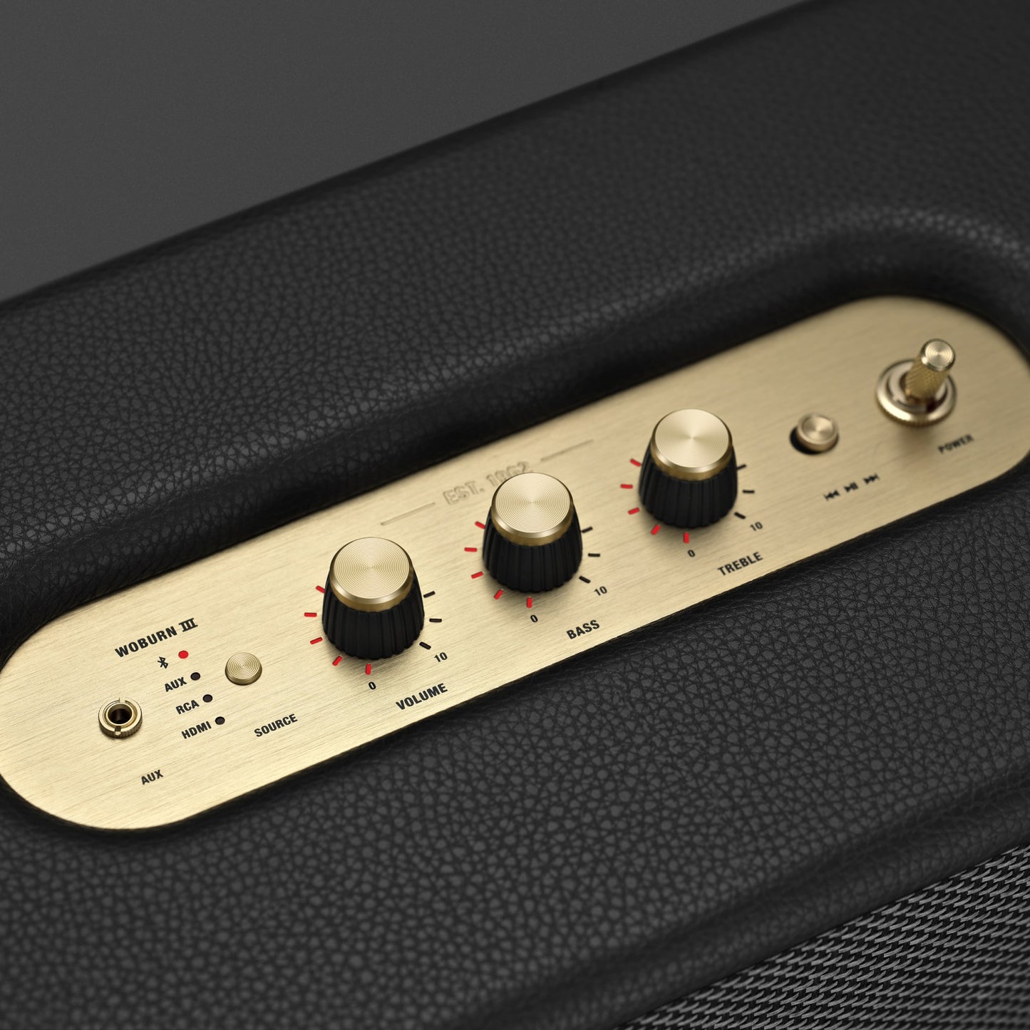 Close-up of Marshall Woburn III brass control knobs and script logo